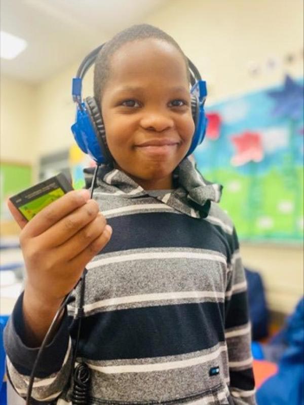 Student listening to the Walking Classroom